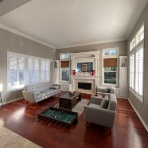 White plantation shutters, or indoor shutters, on living room windows.