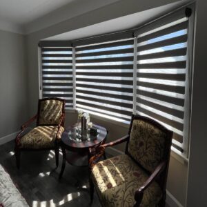 Dark grey banded shades, or zebra shades, on large windows.