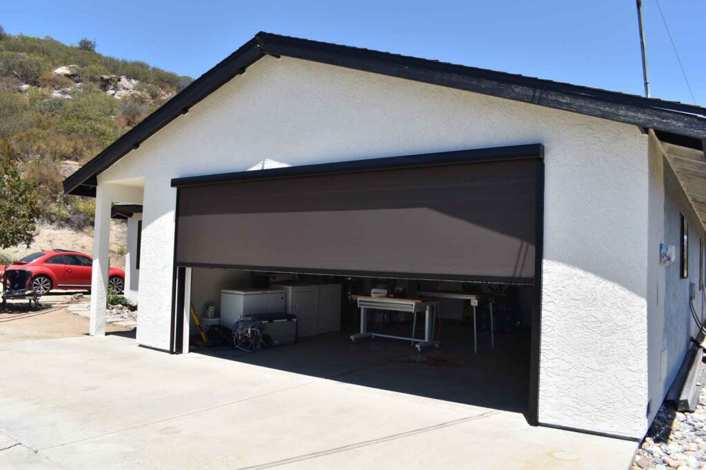 Motorized outdoor shade on garage